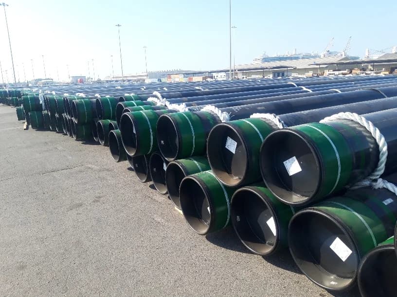 Rows of steel pipes stored at a port.