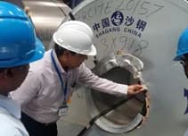 Surveyor inspecting the end of a steel coil.