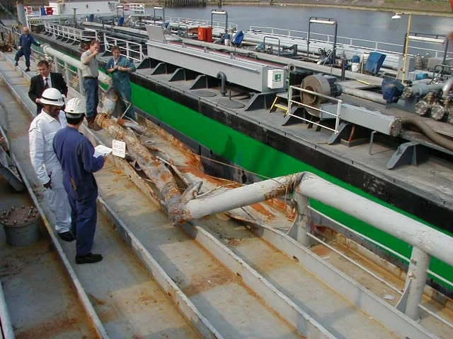 Surveyors inspecting the hull and machinery of a vessel.